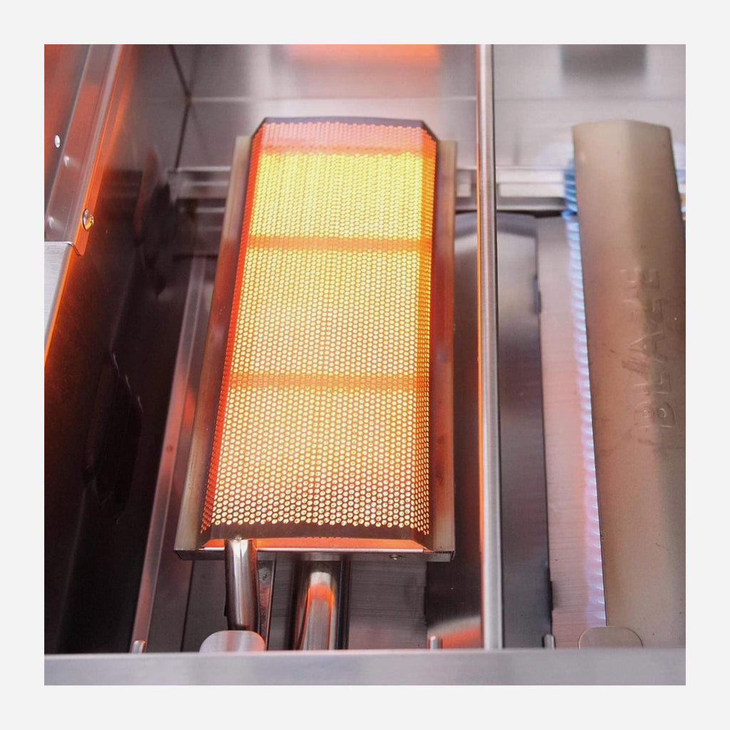 Top view of Blaze 14,000 BTU burner in LTE2 gas grill. Burner is left side and and burning gas. Model is BLZ-IRN.