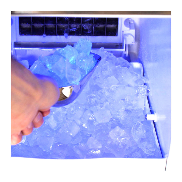 Inside view, Blaze 15" outdoor ice maker full of ice cubes. Model is BLZ-ICEMKR-50GR.